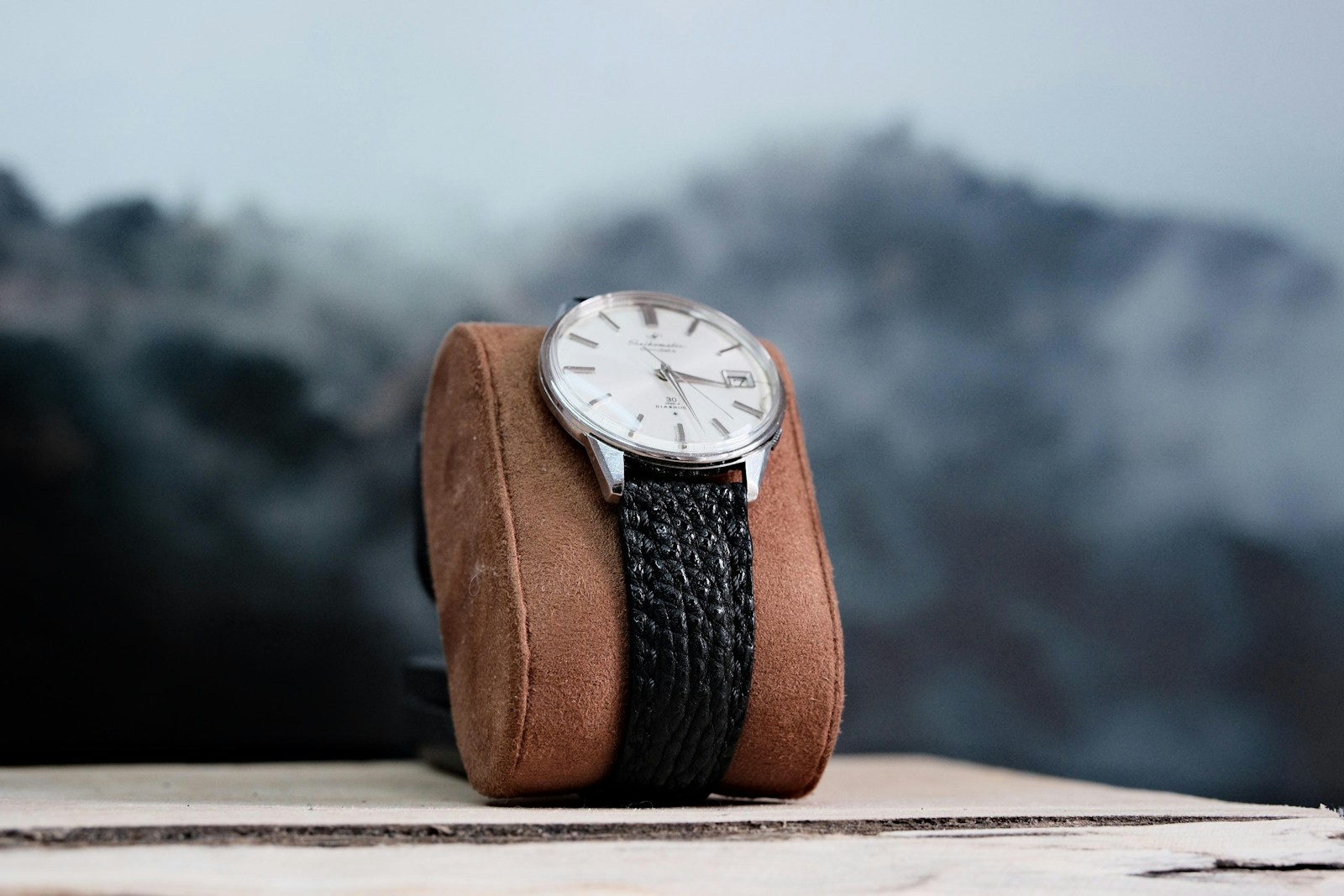 a watch sitting on top of a leather case